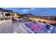 The backyard features a hot tub, seating and fire pit with beautiful views of the city and mountains at 3000 Dusky Willow Ln, Las Vegas, NV 89138