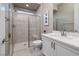 Elegant bathroom with a glass shower, white vanity with quartz countertops, and modern fixtures at 3000 Dusky Willow Ln, Las Vegas, NV 89138