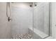 Modern tiled shower featuring a bench and mosaic flooring at 3000 Dusky Willow Ln, Las Vegas, NV 89138