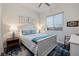 Cozy bedroom featuring a white wooden bed frame, blue accents, and stylish decor at 3000 Dusky Willow Ln, Las Vegas, NV 89138