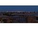 Night view of the illuminated city skyline from the property's elevated outdoor space at 3000 Dusky Willow Ln, Las Vegas, NV 89138