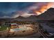 An aerial view of the community pool and desert landscape with beautiful mountain views at sunset at 3000 Dusky Willow Ln, Las Vegas, NV 89138