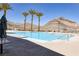 A clear view of a community pool area surrounded by desert landscaping and framed by distant mountain views at 3000 Dusky Willow Ln, Las Vegas, NV 89138