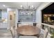 Stylish dining area with built-in bar, open to the kitchen, and views of the outdoor living space at 3000 Dusky Willow Ln, Las Vegas, NV 89138