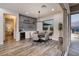Bright dining area featuring a built-in bar, modern lighting, and sliding glass doors to an outdoor living space at 3000 Dusky Willow Ln, Las Vegas, NV 89138