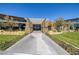 Impressive entrance with modern architectural features, lush landscaping, and a welcoming walkway at 3000 Dusky Willow Ln, Las Vegas, NV 89138