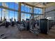 Fully-equipped fitness center with stone accent walls, large windows with pool views, and modern machines at 3000 Dusky Willow Ln, Las Vegas, NV 89138
