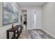 A modern foyer with wood floors, art, and an entry door with sidelight allows lots of natural light at 3000 Dusky Willow Ln, Las Vegas, NV 89138