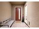 The front porch has a seating bench, flower pot and a decorative front door with welcome mat at 3000 Dusky Willow Ln, Las Vegas, NV 89138