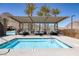 Hot tub featuring an overhead shade structure, resort-style seating, and desert landscaping with mountain views at 3000 Dusky Willow Ln, Las Vegas, NV 89138