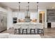 Modern white kitchen features stainless appliances and a large island with barstool seating at 3000 Dusky Willow Ln, Las Vegas, NV 89138