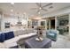 Open floor plan living room and kitchen with view of the dining area and access to outdoor area at 3000 Dusky Willow Ln, Las Vegas, NV 89138