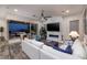 A modern living room features a fireplace, fan and large glass doors to the outdoor entertaining area at 3000 Dusky Willow Ln, Las Vegas, NV 89138