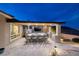 An outdoor kitchen features a pizza oven, built in BBQ, bar seating, and TV for outdoor entertaining at 3000 Dusky Willow Ln, Las Vegas, NV 89138