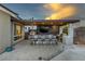 An outdoor kitchen features a pizza oven, built in BBQ, bar seating, and TV for outdoor entertaining at 3000 Dusky Willow Ln, Las Vegas, NV 89138