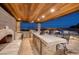 This outdoor kitchen has stainless appliances, pizza oven, marble counters, bar seating and overlooks the city at 3000 Dusky Willow Ln, Las Vegas, NV 89138