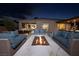 Inviting outdoor patio with an outdoor kitchen and comfortable seating surrounding a modern fire pit at 3000 Dusky Willow Ln, Las Vegas, NV 89138