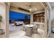 Inviting outdoor space with a kitchen, hot tub, comfortable seating, and city views at 3000 Dusky Willow Ln, Las Vegas, NV 89138