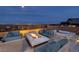 Luxurious outdoor living space with a modern fire pit, comfortable seating, and a relaxing hot tub at 3000 Dusky Willow Ln, Las Vegas, NV 89138