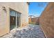 Back patio with brick walls and door leading inside at 3314 Villa Fiori Ave, Las Vegas, NV 89141