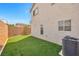 Private backyard with artificial grass, and low-maintenance landscaping at 3314 Villa Fiori Ave, Las Vegas, NV 89141