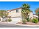 A two-story home displaying the garage, landscaping, and a corner view at 3314 Villa Fiori Ave, Las Vegas, NV 89141