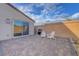 This backyard includes a brick-lined patio, outdoor seating, and a gas grill at 3495 Luca Point Ave, Henderson, NV 89044