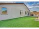 This backyard includes a putting green, brick-lined patio, and a gas grill at 3495 Luca Point Ave, Henderson, NV 89044