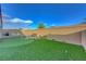 This backyard includes a putting green, outdoor seating, and a gas grill at 3495 Luca Point Ave, Henderson, NV 89044