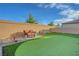 This backyard includes a putting green and outdoor seating near a well-maintained surrounding wall at 3495 Luca Point Ave, Henderson, NV 89044
