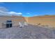 This backyard includes a brick-lined patio, outdoor seating, and a gas grill at 3495 Luca Point Ave, Henderson, NV 89044