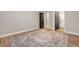 Neutral bedroom with decorative rug, wood-look flooring, and modern doors at 3495 Luca Point Ave, Henderson, NV 89044