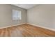 A bright and clean bedroom features minimalist aesthetic with wood flooring at 3495 Luca Point Ave, Henderson, NV 89044