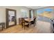 Cozy dining area with wood flooring, a wooden table, and sliding glass doors to the backyard at 3495 Luca Point Ave, Henderson, NV 89044