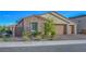 Beautiful single-story home with stone accents, three-car garage, and a well-kept front yard at 3495 Luca Point Ave, Henderson, NV 89044