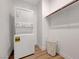 A laundry area with a stackable washer and dryer and a wire basket at 3495 Luca Point Ave, Henderson, NV 89044