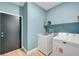 Convenient laundry room includes modern washer and dryer set, plus functional shelving at 3495 Luca Point Ave, Henderson, NV 89044