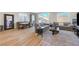 Bright and open living room area with dining space, featuring sliding glass doors and wood-look flooring at 3495 Luca Point Ave, Henderson, NV 89044