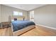 The primary bedroom offers a well-lit space with wood-look floors and a cozy king bed at 3495 Luca Point Ave, Henderson, NV 89044