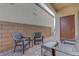 Cozy outdoor patio with stylish wicker furniture and brick-paved flooring, perfect for relaxing and entertaining at 3495 Luca Point Ave, Henderson, NV 89044