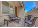 Charming outdoor patio with comfortable wicker furniture and access to a landscaped yard at 3495 Luca Point Ave, Henderson, NV 89044
