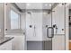 Modern shower featuring dual shower heads, sleek fixtures, and mosaic tile flooring at 3495 Luca Point Ave, Henderson, NV 89044