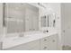 Bathroom with double sinks, white cabinets, and a large mirror at 390 Inflection St, Henderson, NV 89011