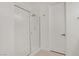 Bright bathroom featuring a glass shower and white paneled door at 390 Inflection St, Henderson, NV 89011