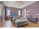 Bedroom with wood floors, ceiling fan, and comfortable seating area at 390 Inflection St, Henderson, NV 89011
