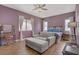 Bedroom featuring wood floors, a makeup vanity, and comfortable seating at 390 Inflection St, Henderson, NV 89011