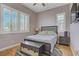Bedroom featuring a queen bed, wood floors, plantation shutters, and modern decor at 390 Inflection St, Henderson, NV 89011