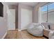 Bedroom with a beanbag chair, wood floors, and natural light from a window at 390 Inflection St, Henderson, NV 89011