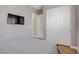 Bedroom with sleek gray walls, wood floors, and a sliding door closet at 390 Inflection St, Henderson, NV 89011