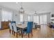 Dining area with a modern chandelier above the table and views into the living room at 390 Inflection St, Henderson, NV 89011